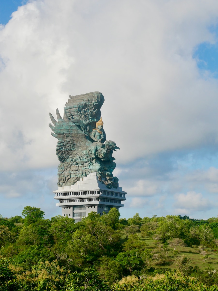 a large statue of a bird on top of a building