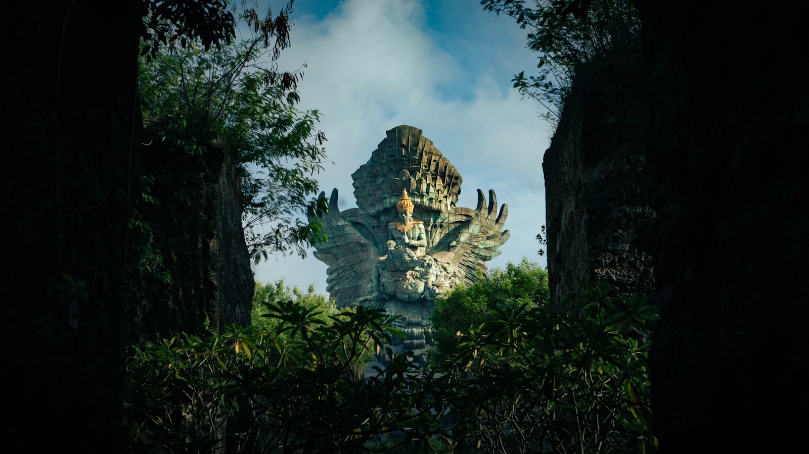 A statue in the middle of a forest