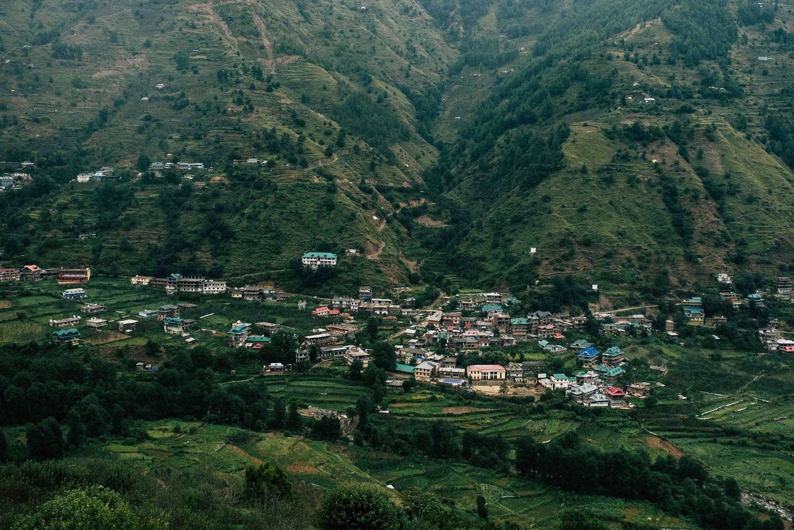 a small village nestled in a valley surrounded by mountains